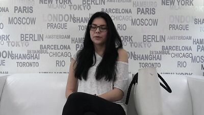 Cute young gal with glasses is interviewed on a porn casting