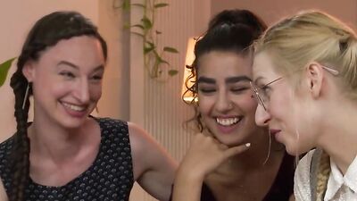 Four naked and horny girls are having sex on the couch