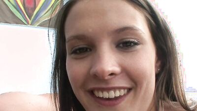 Dirty girl smiles at the camera with a dick in her mouth