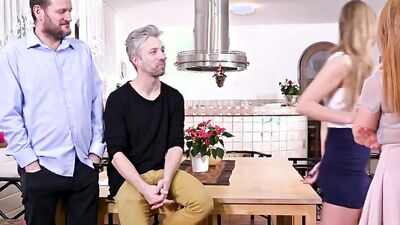 Two foxy girls are sucking cocks and fucking in the kitchen