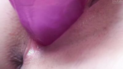 Sensual brunette babe is sticking a huge dildo in her cunt
