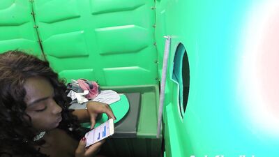 Black babe finds a hole in the toilet and a dick sticking out of it