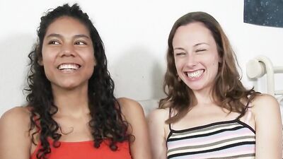 Tanned curly babe gets her pussy fingered by white brunette