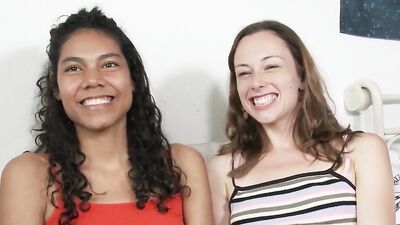 Tanned curly babe gets her pussy fingered by white brunette