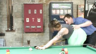 Tattooed chick is riding her partner's cock on top of pool table