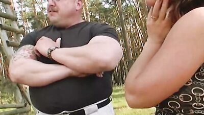A sexy brunette German slut enjoys pleasing two hard cocks outdoors