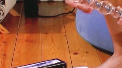 A beautiful and horny German blonde using her glass dong