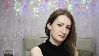Brunette amateur with naked shoulders on webcam