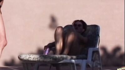 A bunch of guys spot a babe sunbathing in the nude and give her bukkake