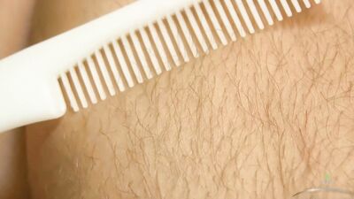 Unshaved woman combs her luscious body hair and massages her bushy cunt.