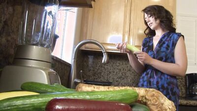 MILF washes a cucumber and ends up masturbating with it before using other veggies