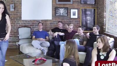 A group of girls are playing a strip game in the living room