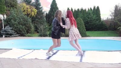 Three girls are playing trip wrestling outdoors