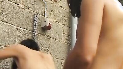 Pretty German babe tied up and fucked in a threesome outdoors