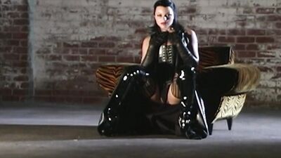 Tattoed brunette sex goddes wearing sexy outfit is being fucked in a dark room.