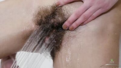 Lillian slips into the bath and fingers her wet hairy pussy