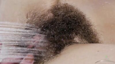Lillian slips into the bath and fingers her wet hairy pussy