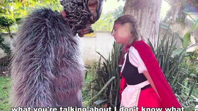 Little Red Riding Hood lost a fruit from her basket and is looking for it in the wolf's pants.