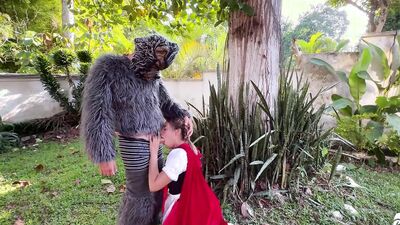 Little Red Riding Hood lost a fruit from her basket and is looking for it in the wolf's pants.