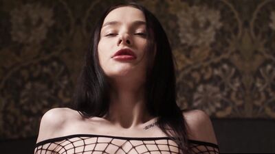 Kinky girl rubs her fishnet clad feet against her bare pussy