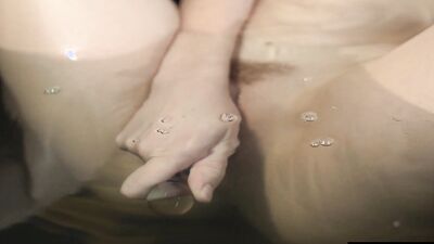 Big soapy breasts and a slick pussy as she masturbates avidly