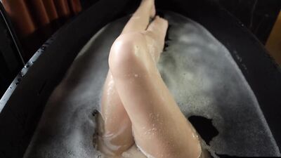 Big soapy breasts and a slick pussy as she masturbates avidly