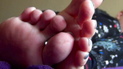 Watch this stunning brunette babe ignore her toes and play with her long, long feet up close and personal