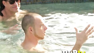 Busty swinger babe is naked having oral sex in the pool.