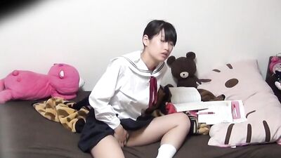 Hidden camera caught a Japanese schoolgirl rubbing her hairy pussy