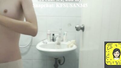 Woman is filming herself while being naked in a bathroom and putting on a lotion