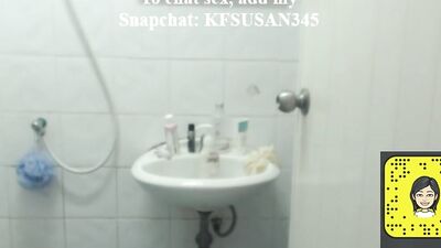 Woman is filming herself while being naked in a bathroom and putting on a lotion