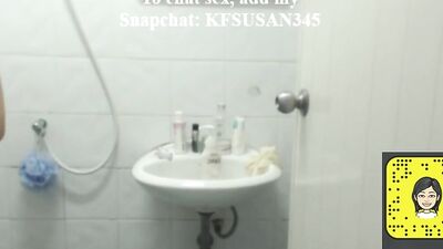 Woman is filming herself while being naked in a bathroom and putting on a lotion