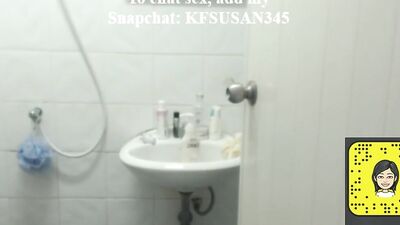 Woman is filming herself while being naked in a bathroom and putting on a lotion
