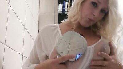 Busty amateur MILF is squeezing her big boobs for you while in a bathroom