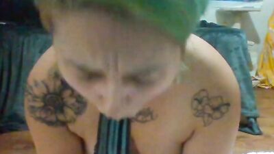 Solo amateur woman with tattoos is sucking off and riding her favorite dildo