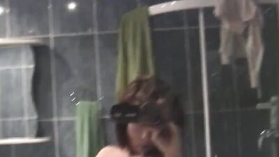 Natural amateur babe is filming herself with a hand-held camera while masturbating