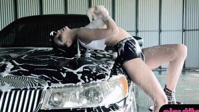 Enjoy a smoking hot busty babe who is washing a car topless