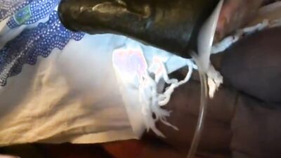 Amateur harlot stuffs her mouth with a big black dildo while getting banged