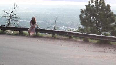 Lonely ginger doll is filmed while using a magic wand outdoors